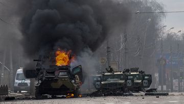 A Russian armoured personnel carrier burns amid damaged and abandoned light utility vehicles after fighting in Kharkiv, Ukraine, Sunday, Feb. 27, 2022. 
