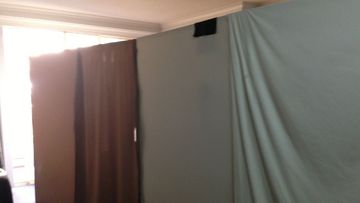 Pieces of cardboard and faded sheets divide the tiny Ultimo unit between living area and 'bedroom'. (Supplied)