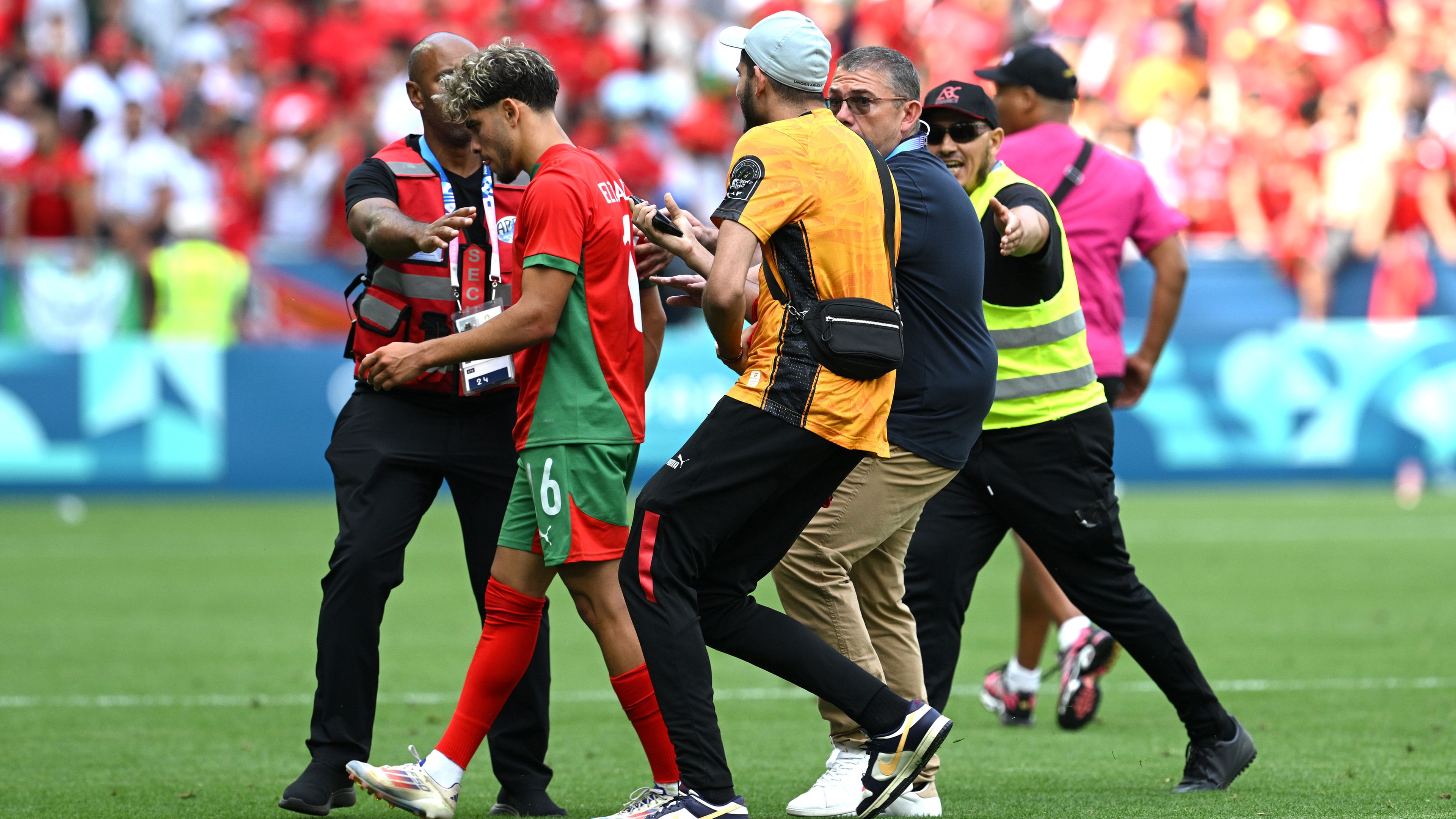 Morocco&#x27;s Abde Ezzalzouli is followed by pitch invaders during the men&#x27;s group B match between Argentina and Morocco at the Olympic Games Paris 2024.