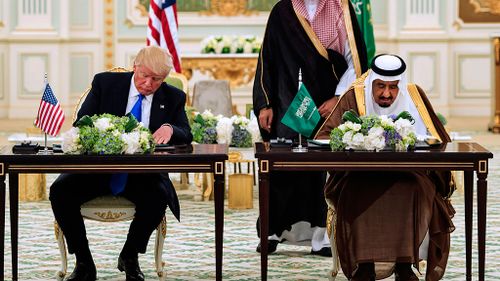 US President Donald Trump (L) and Saudi Arabia's King Salman bin Abdulaziz al-Saud attending a signing ceremony at the Saudi Royal Court in Riyadh. (AFP)