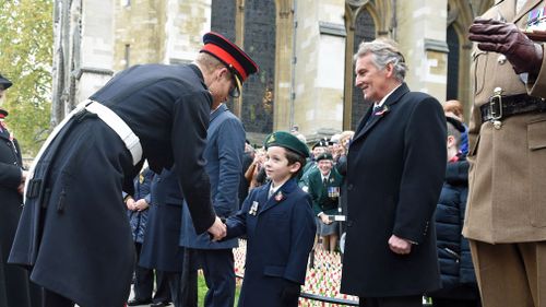 Harry shakes hands with a child. (AAP)