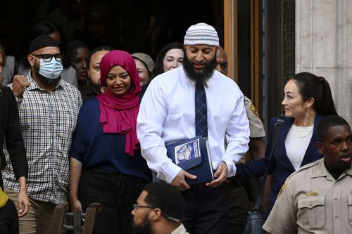 Adnan Syed, center right, leaves the courthouse after a hearing on Sept. 19, 2022