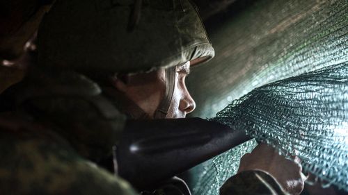 A pro-Russian serviceman sits in the advanced trenches of the people's militia of the Donetsk People's Republic in the Yasne village area, Donbas
