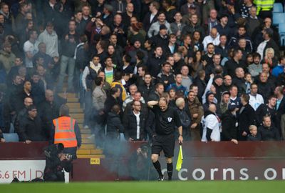 <b>Two men have been arrested after a linesman was hit by a smoke bomb at an English Premier League match.</b><br/><br/>Tottenham Hotspur had just taken the lead against Aston Villa when it's believed one of their fans threw the canister toward the playing surface.<br/><br/>Trailing black smoke, it hit the assistant referee on the neck, causing him to stumble forward and forcing a stoppage in play.<br/><br/>In any form, objects thrown from the stands can be incredibly dangerous, as these videos prove...