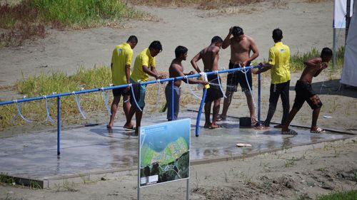 Participants at the World Scout Jamboree in South Korea cool down at a water supply zone on August 4.