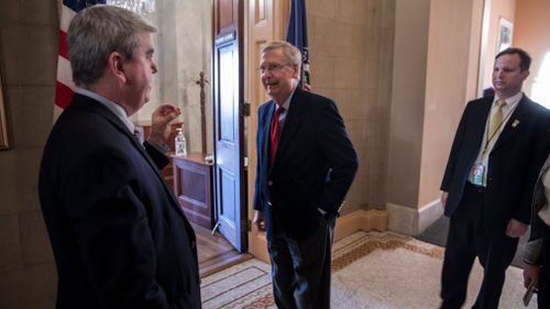 Senate Majority Leader Mitch McConnell (centre) outside his office as the Senate works on ending shutdown. (AAP)