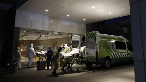 A resident of Epping Gardens Aged Care Facility is taken away in a ambulance in Melbourne, Australia. 