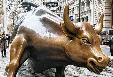 Charging Bull is situated on a traffic median in which New York street?