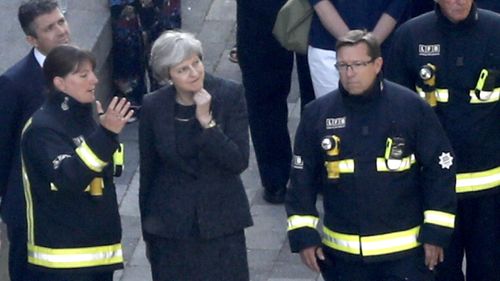 Prime Minister Theresa May visits emergency services at the scene of the fatal fire. (AFP)