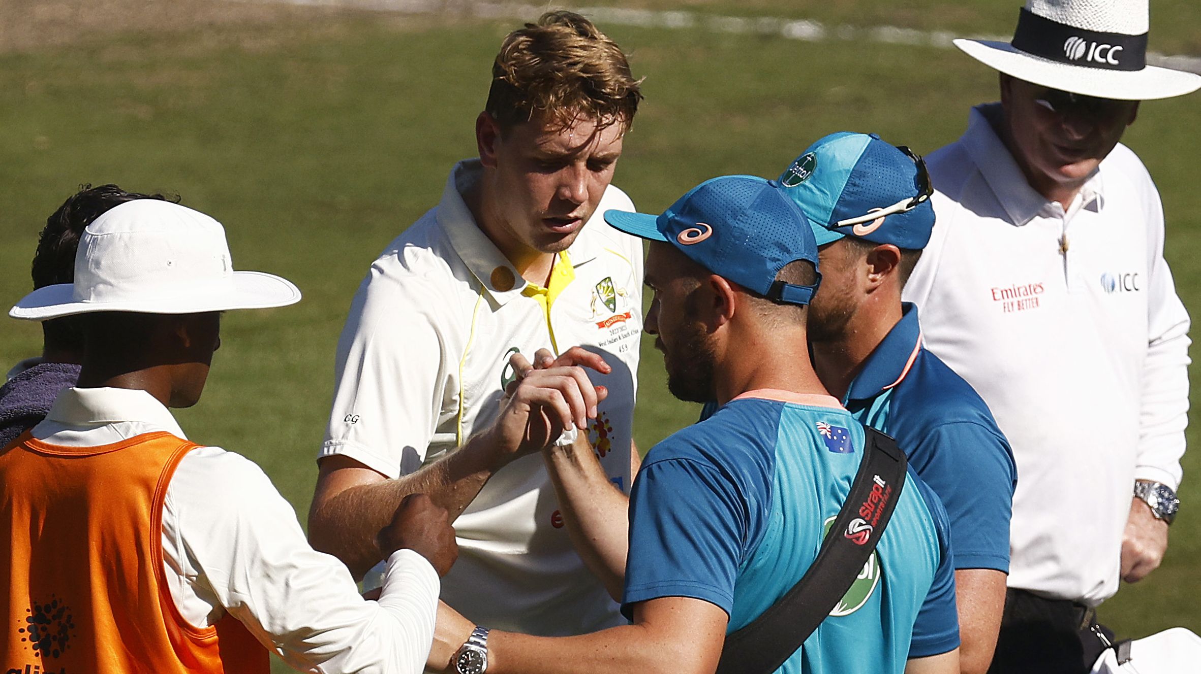 Cameron Green of Australia receives treatment for a cut finger on his right hand. (Photo by Daniel Pockett - CA/Cricket Australia via Getty Images)