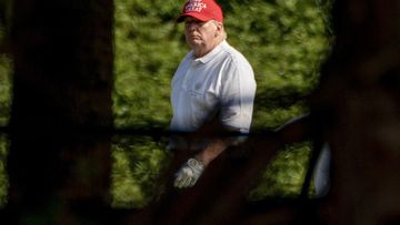 President Donald Trump plays golf at his Trump International Golf Club in West Palm Beach, Florida.