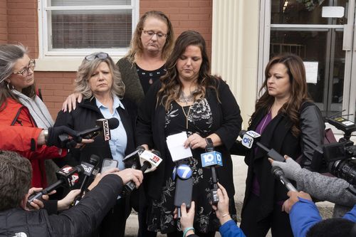 Tonya McCoy, from left, April Manley and Lisa Weisel stand on the steps of the Pike County Courthouse, Monday, Dec. 19, 2022, in Waverly, Ohio. George Wagner IV who was convicted in the killings of eight members of an Ohio family was sentenced Monday to life in prison without the possibility of parole. 