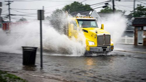 A truck makes its way through the flooding caused by Tropical Storm Elsa in New York.