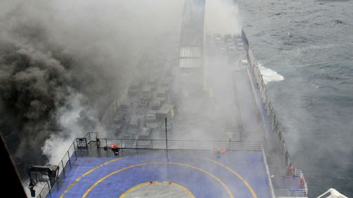 Smoke and flame bellow from the ferry. (AAP)