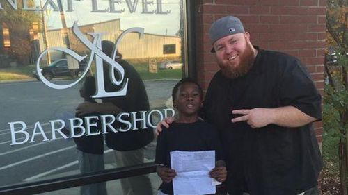 Kamarian Fox, 9, and barber Mike Shelton. (Social Media)