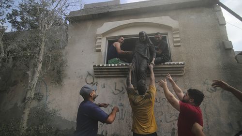 Palestinians evacuate a building