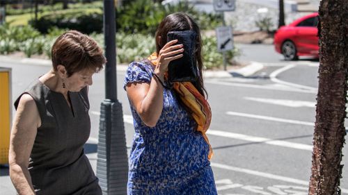 Maria Playford (right) leaves the Brisbane Supreme Court with a friend after the sentencing of her former husband. (Image: AAP)