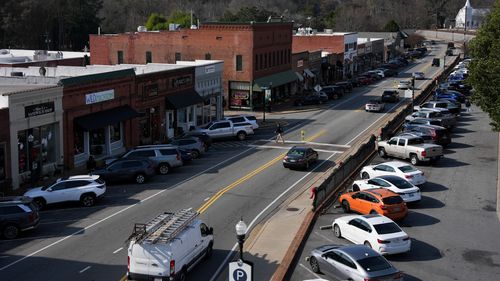 Cars drive through downtown Acworth, Georgia, on December 17, 2025.