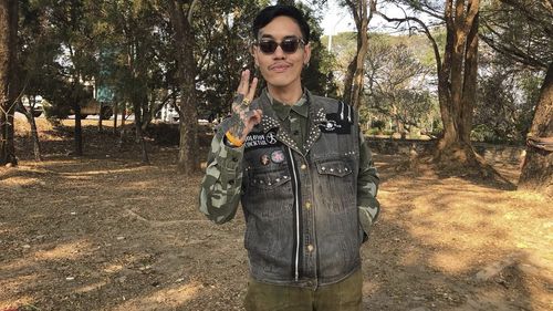 Political activist Mongkhon Thirakot flashes the pro-democracy gesture of a three-finger salute ahead of going to a court in Thailand's northern province of Chiang Rai.