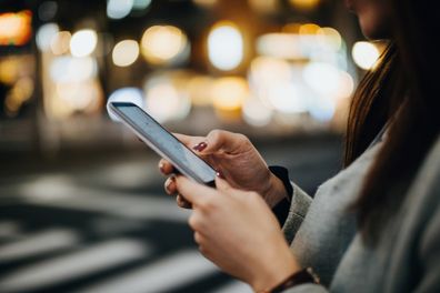 Woman on smart phone at night