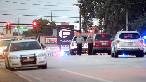 Police cars surround the Pulse Orlando nightclub. (AAP)