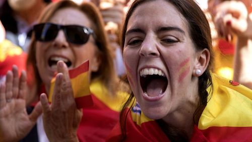 Demonstrators shout slogans as thousands of people march to protest the Catalan government's push for secession from the rest of Spain in downtown Barcelona. (AAP)