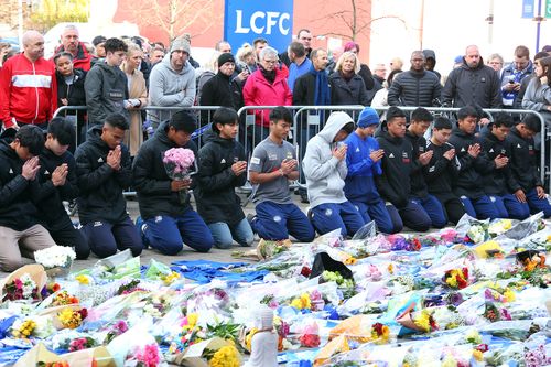 Players of the Fox Hunt Football Academy from Chaiyaphum in Thailand arrive to pay their respects outside the King Power stadium in Leicester