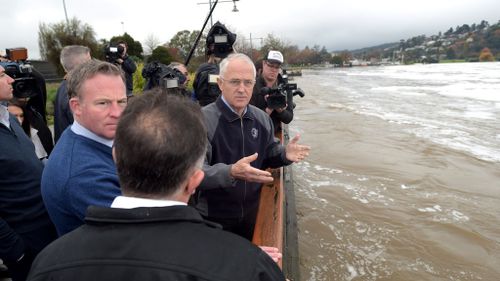 Prime Minister Malcolm Turnbull and Tasmanian Premier Will Hodgman (left) and local MP Andrew Nikolic visit the Launceston levee in Launceston. (AAP)