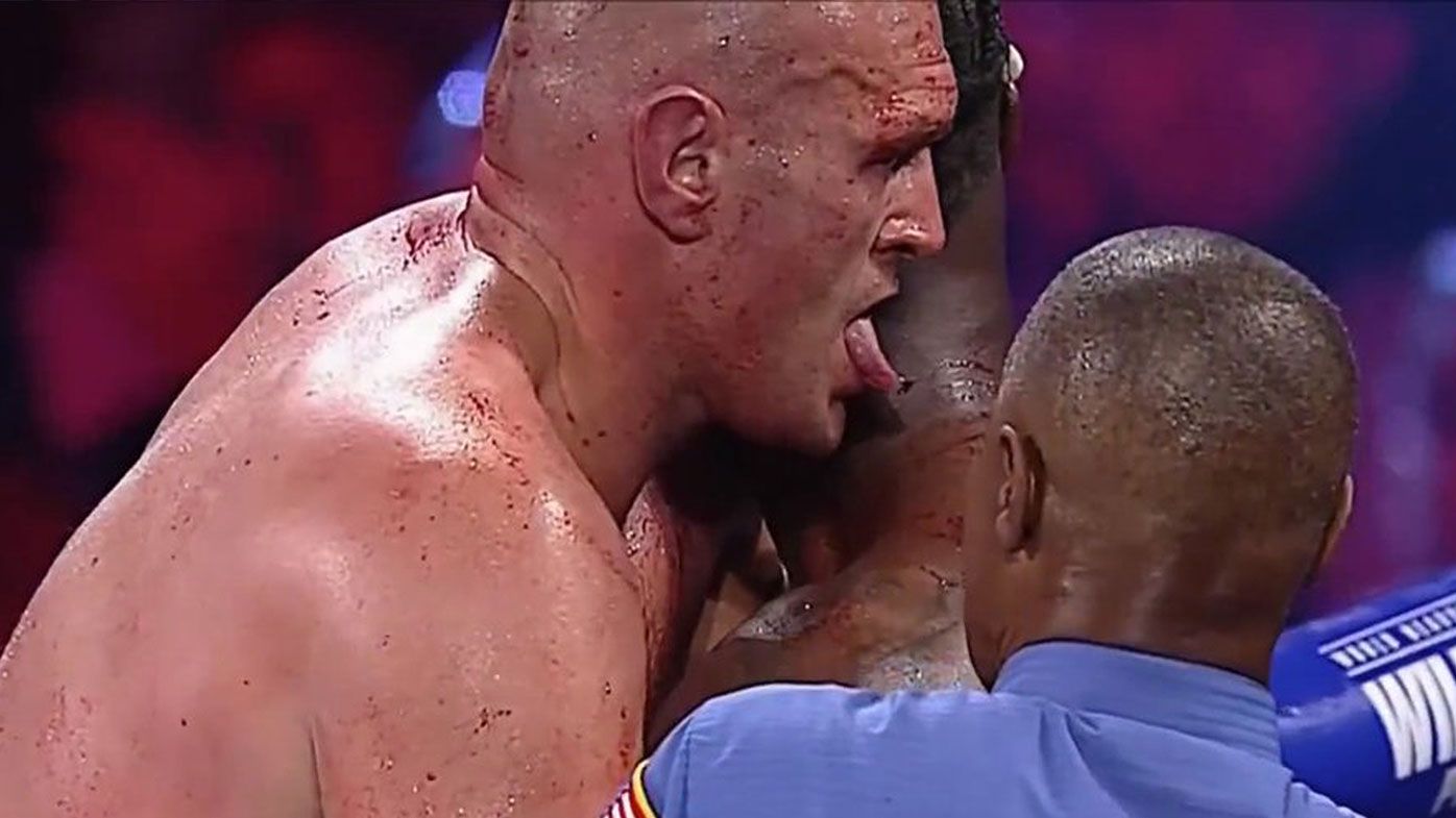 Tyson Fury licks blood off Deontay Wilder during WBC heavyweight bout