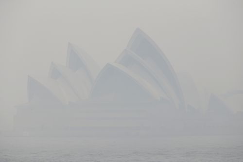 Thick smoke from wildfires shroud the Opera House in Sydney, Australia.