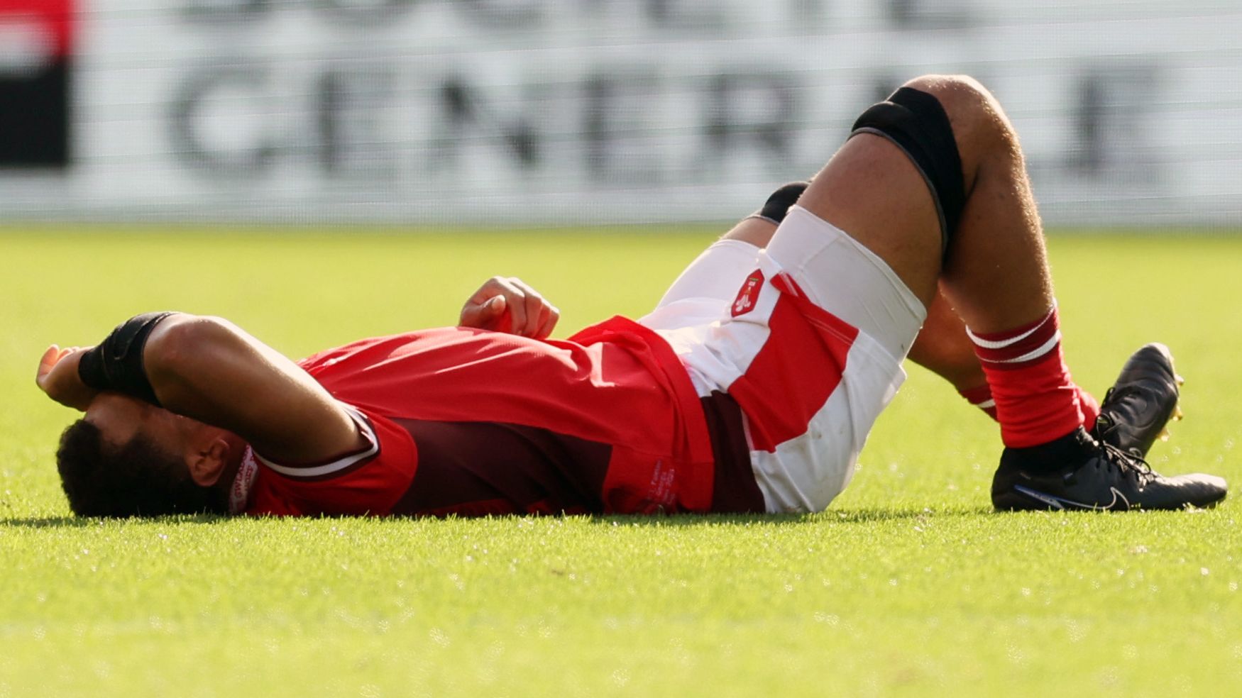 Taulupe Faletau of Wales lays injured at Stade de la Beaujoire.