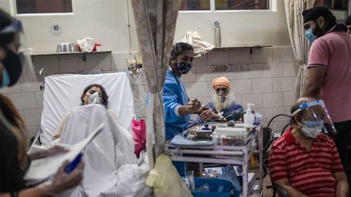 Medical staff attend to Covid-19 positive patients in the emergency ward at the Holy Family hospital in New Delhi, India.