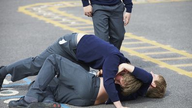 Two Boys Fighting In School Playground During Break Time Bullying students brawling