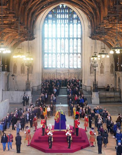 Members of the public file past the coffin of Queen Elizabeth II, draped in the Royal Standard with the Imperial State Crown and the Sovereign's orb and sceptre, lying in state on the catafalque in Westminster Hall, at the Palace of Westminster, ahead of her funeral on Monday, on September 16, 2022 in London, England.  
