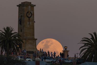 Crowds look on as the Supermoon rises behind the Fremantle War Memorial at Monument Hill on November 14, 2016.