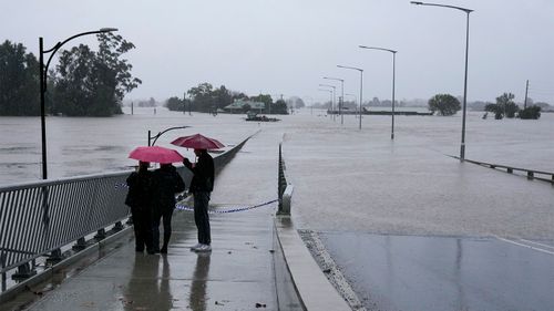 People look at the flooded Windsor Bridge on the outskirts of Sydney.