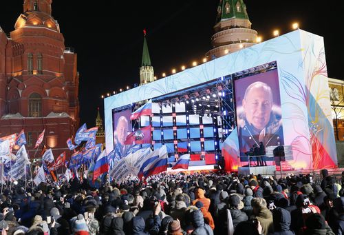 A screen shows presidential candidate, Russian President Vladimir Putin during a rally in his support near Kremlin in Moscow, Russia, 18 March 2018. Russians are electing the President of Russia in the 18 March elections, with eight candidates contesting for the presidential seat, including the incumbent president Vladimir Putin, who leads with over 72 per cent of the vote and projected to win his fourth term in the Kremlin. EPA/MAXIM SHIPENKOV 