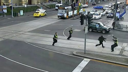 One police officer then sprays the teen with capsicum spray before he lunges at him, knocking the officer to the ground. (Herald Sun)