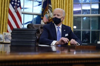 President Joe Biden pauses as he signs his first executive orders in the Oval Office of the White House on Wednesday, Jan. 20, 2021, in Washington. (AP Photo/Evan Vucci)