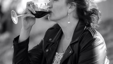 Stock image of a woman drinking wine.