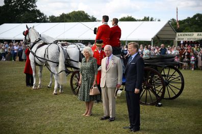 King Charles III and Queen Camilla arrive by horse carriage for their visit to Sandringham Flower Show at Sandringham House on July 26, 2023 in King's Lynn, England 