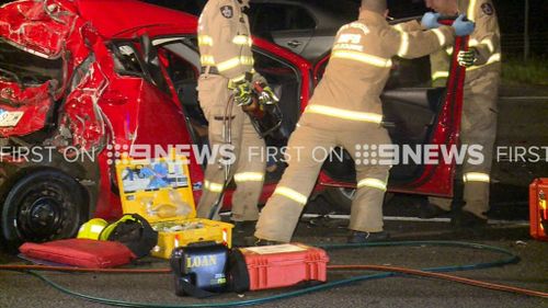Fire crews were forced to cut the woman from her vehicle. (9NEWS)
