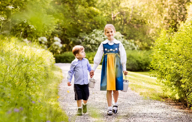 In one sweet image Oscar is pictured looking up at his big sister.