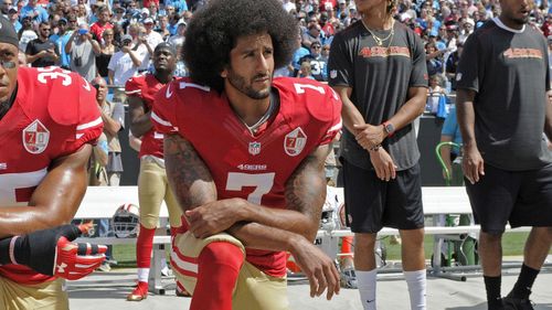 Colin Kaepernick kneels during the US national anthem. (Getty)