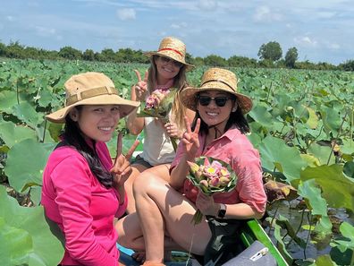 Leanne Savage on a lotus lake in Cambodia with members of the Acala Stem team.