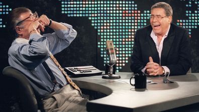 Talk show host Larry King wipes his eyes after laughing at a joke by comedy legend Jerry Lewis, on the set of "Larry King Live" at CNN Studios in the Hollywood section of Los Angeles (Photo: August 26, 1999)