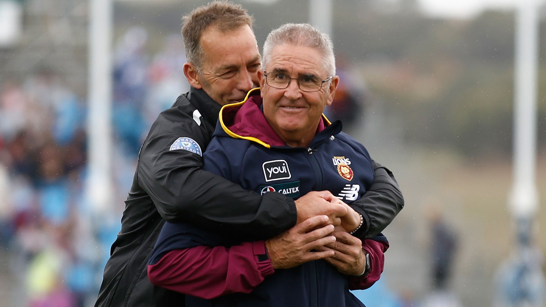 ADELAIDE, AUSTRALIA - APRIL 15: Chris Fagan, Senior Coach of the Lions and Alastair Clarkson, Senior Coach of the Kangaroos embrace before the 2023 AFL Round 05 match between the Brisbane Lions and the North Melbourne Kangaroos at Adelaide Hills on April 15, 2023 in Adelaide, Australia. (Photo by Michael Willson/AFL Photos)