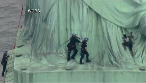 Police officers have closed in on the woman who climbed the Statue of Liberty. Picture: Supplied