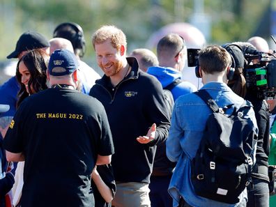THE HAGUE, NETHERLANDS - APRIL 17: (EMBARGOED FOR PUBLICATION IN UK NEWSPAPERS UNTIL 24 HOURS AFTER CREATE DATE AND TIME) Meghan, Duchess of Sussex and Prince Harry, Duke of Sussex (accompanied by a film crew) meet athletes and their supporters at the athletics competition on day 2 of the Invictus Games 2020 at Zuiderpark on April 17, 2022 in The Hague, Netherlands. (Photo by Max Mumby/Indigo/Getty Images)