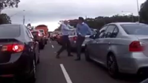 The two men could be seen swinging fists at each other in Terrey Hills yesterday afternoon (Dash Cam Owners Australia)